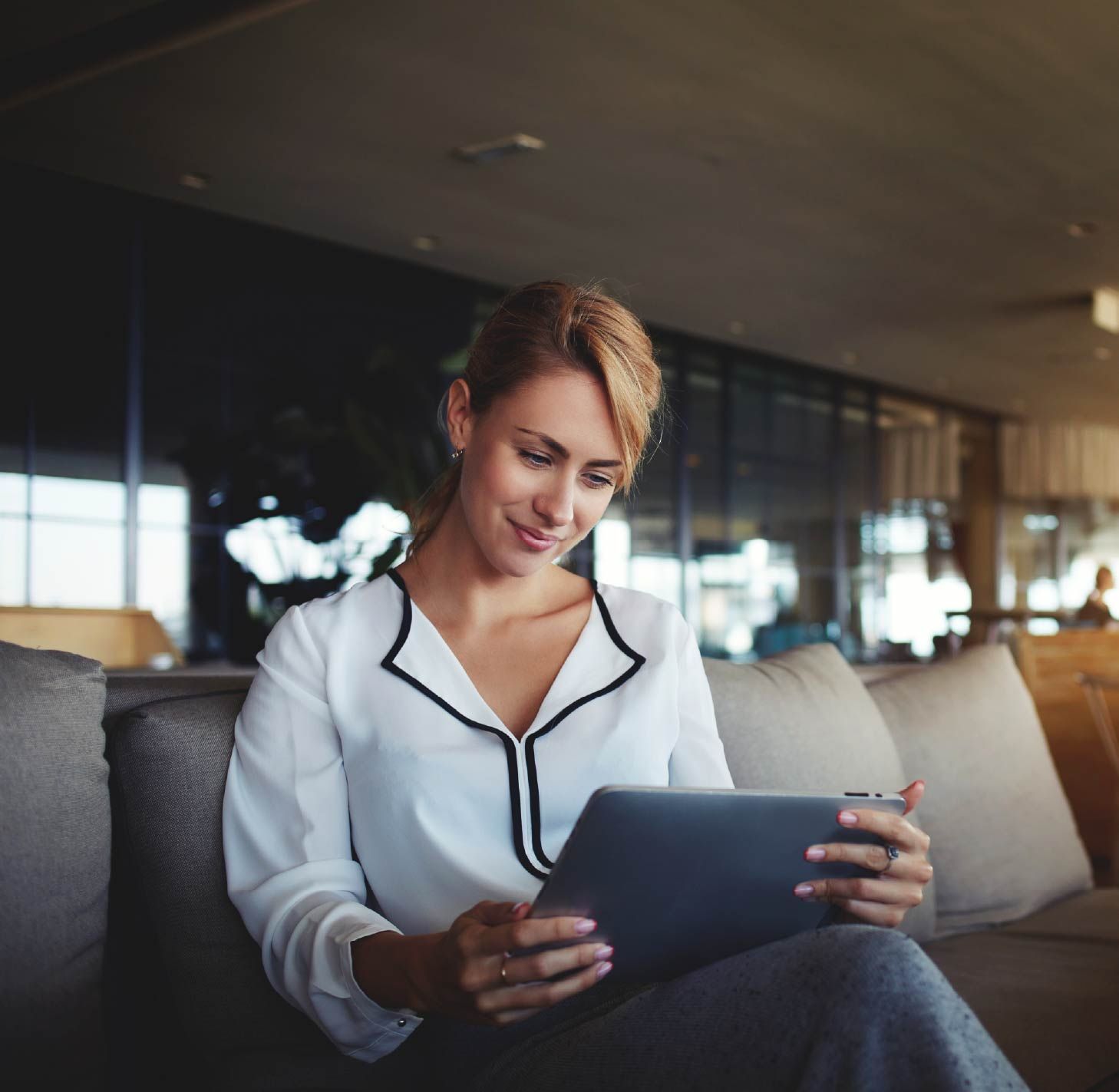 Woman studying an online course on a tablet at home